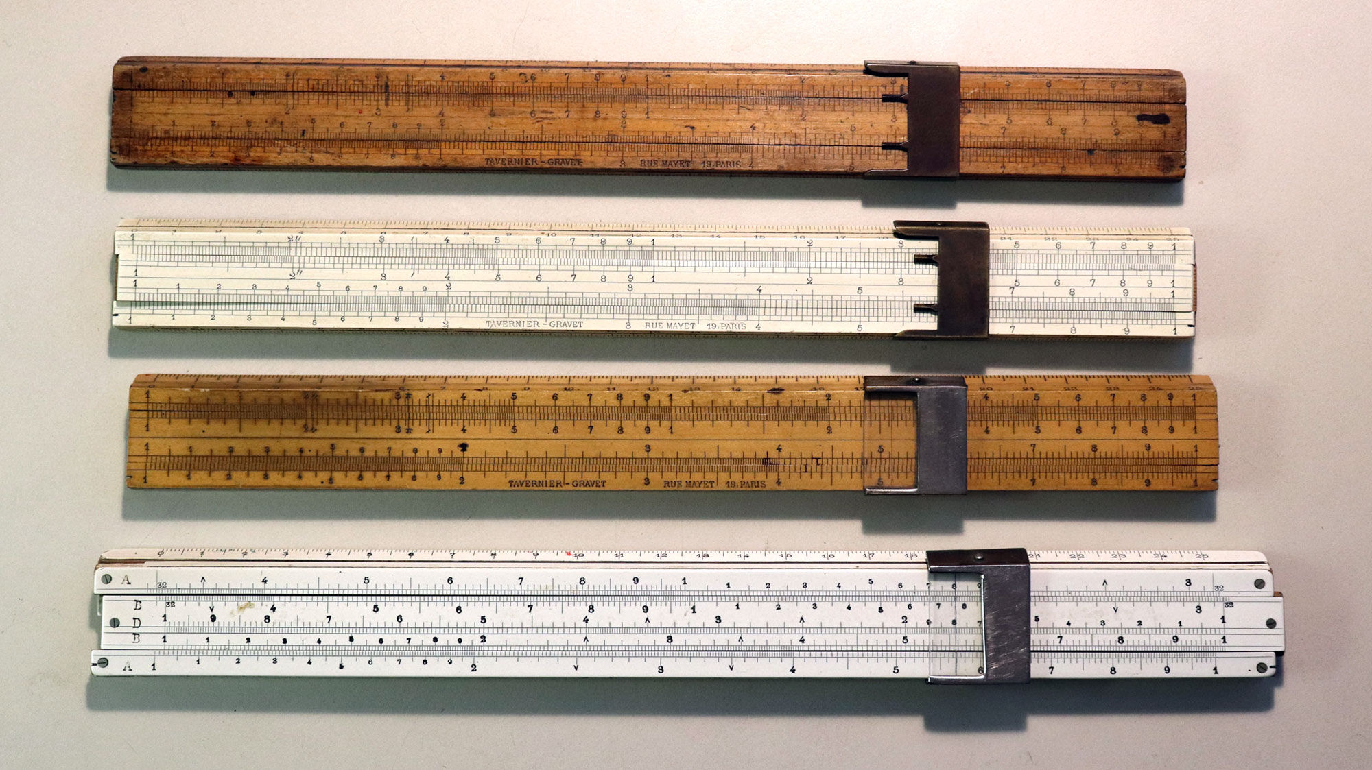 Four Tavernier-Gravet slide rules - front