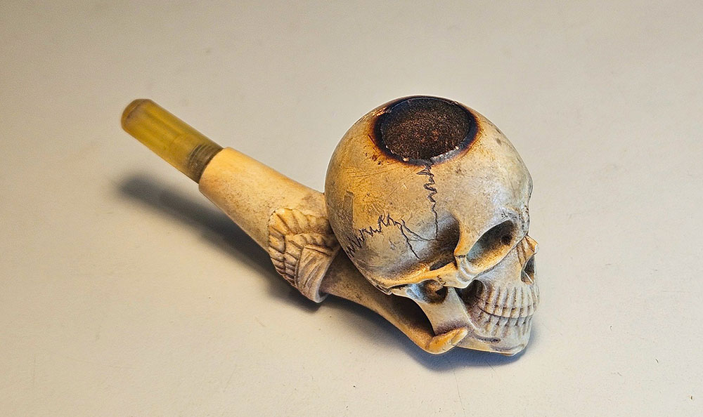 Memento mori! 1 A memento mori meerschaum pipe in the form of a skull in a hand